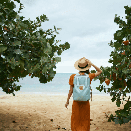 catalyst_lady_backpack_2 a woman wearing a backpack facing the beach